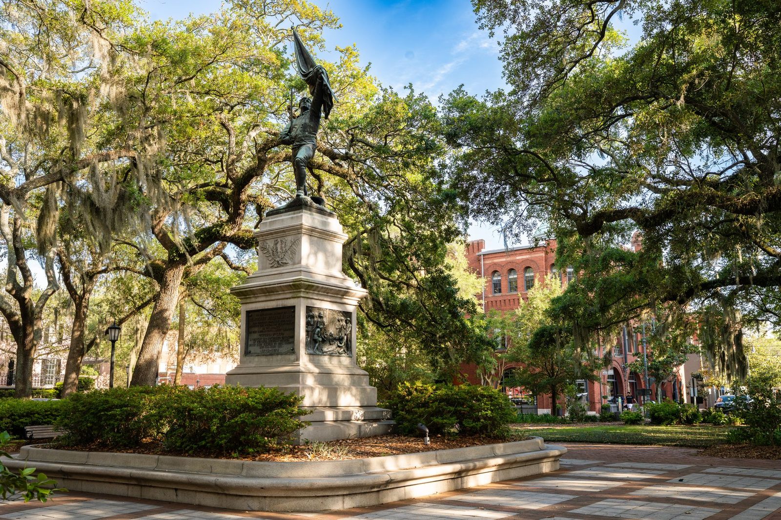 A Savannah square with live oaks, Spanish moss and historic brick buildings